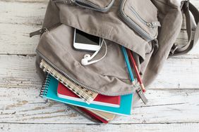 Backpack with school supplies, phone
