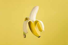Half-Peeled Banana on Yellow Background