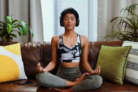 The best free meditation apps: woman meditating at home