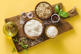 Is Rice Healthy? Four Varieties of Rice in Bowls on a Wooden Cutting Board